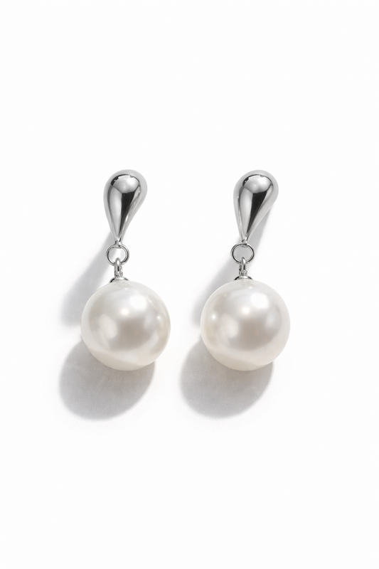 Pearl earrings with silver hooks on a white background