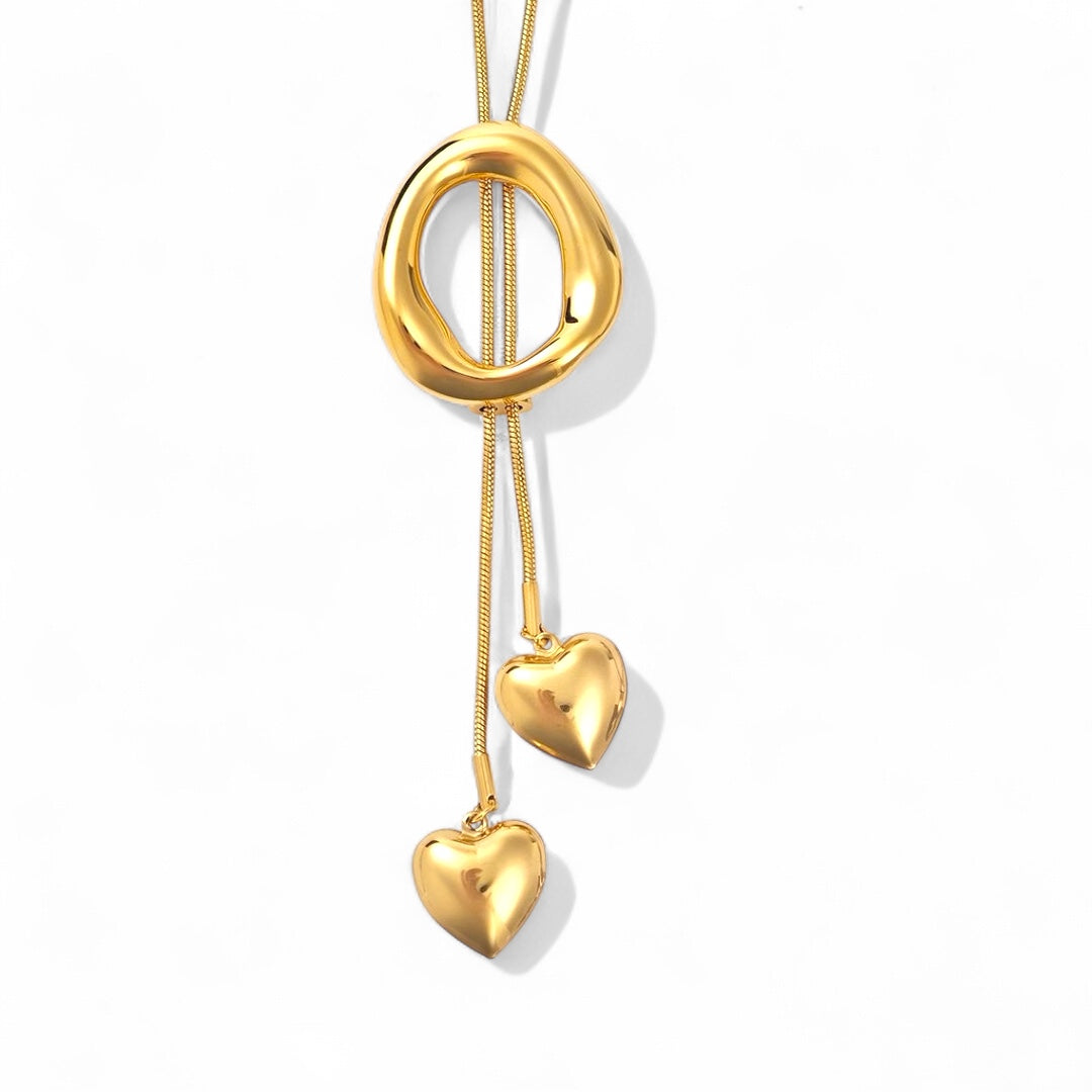 Ατσάλινο κολιέ με ρευστό οβάλ κρίκο και καρδιές – So Cute by Dimi