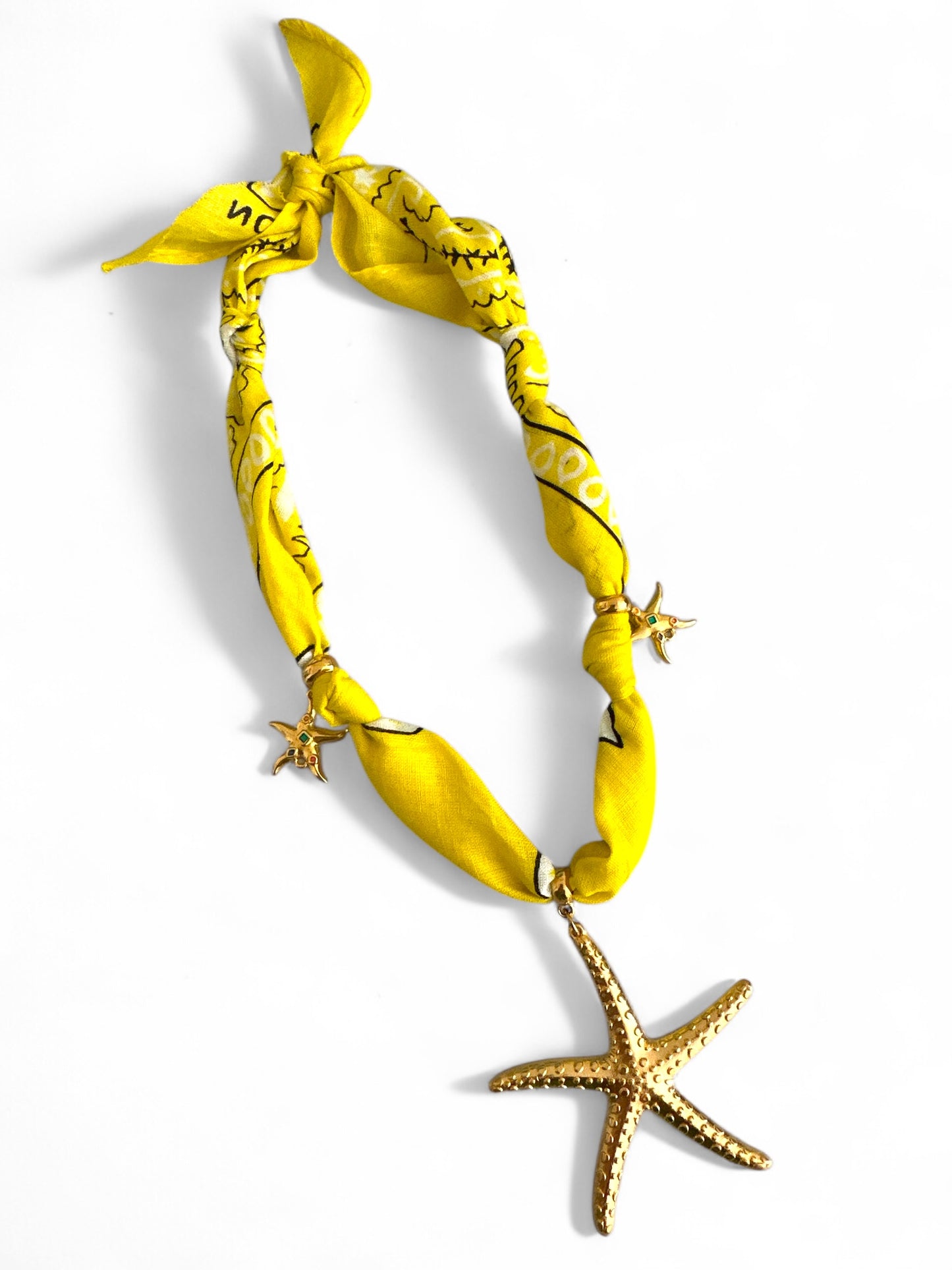 Yellow bandana necklace with starfish decorations on a white background