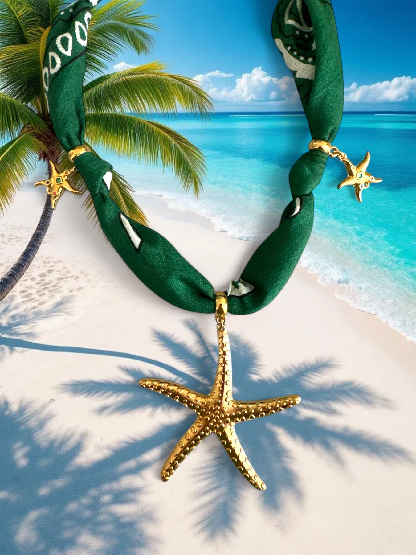 Green bandana necklace with gold starfish pendants on a tropical beach