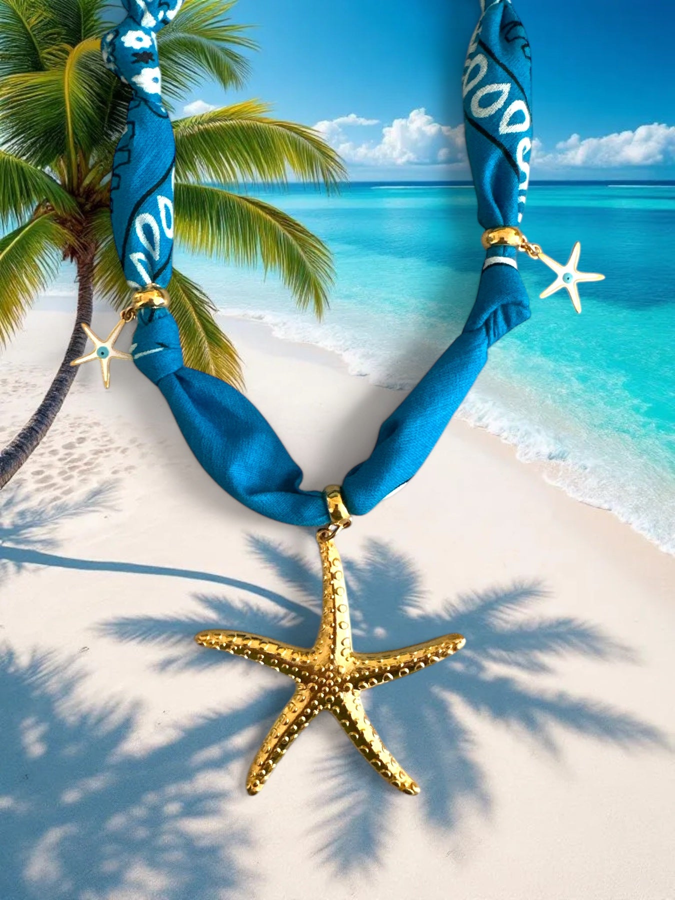 Blue bandana necklace with gold starfish pendant on a tropical beach