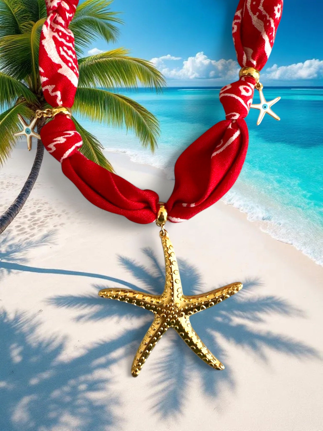 Red bandana necklace with a gold starfish pendant on a tropical beach