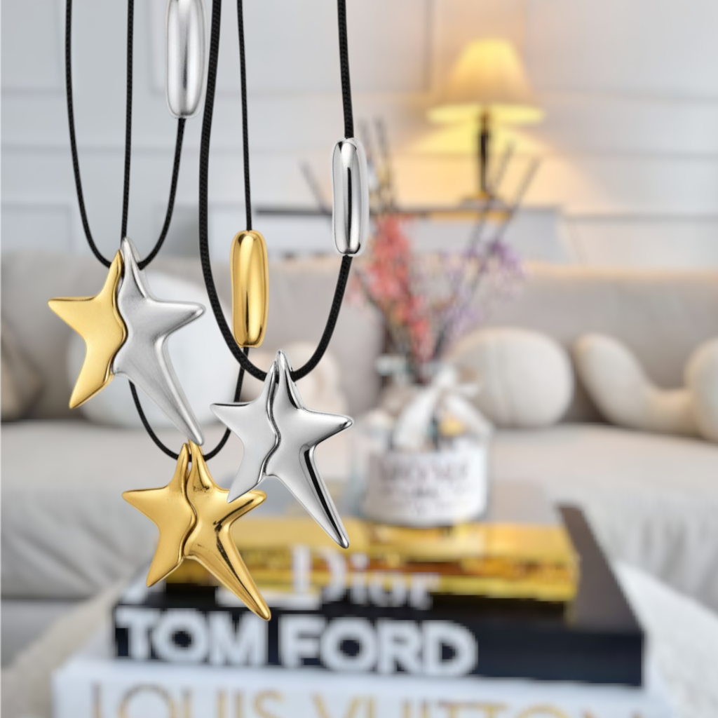 Star-shaped necklaces in gold and silver on a blurred indoor background- So cute by dimi