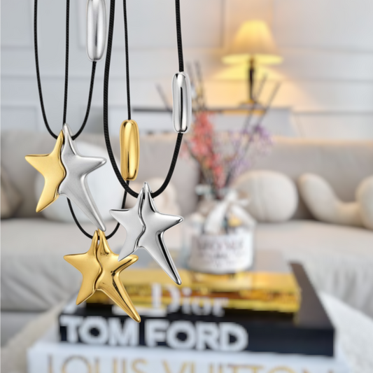 Star-shaped necklaces in gold and silver on a blurred indoor background- So cute by dimi