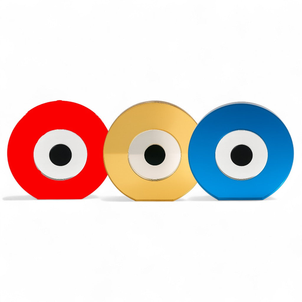 Three circular objects with eye-like designs in red, gold, and blue on a white background