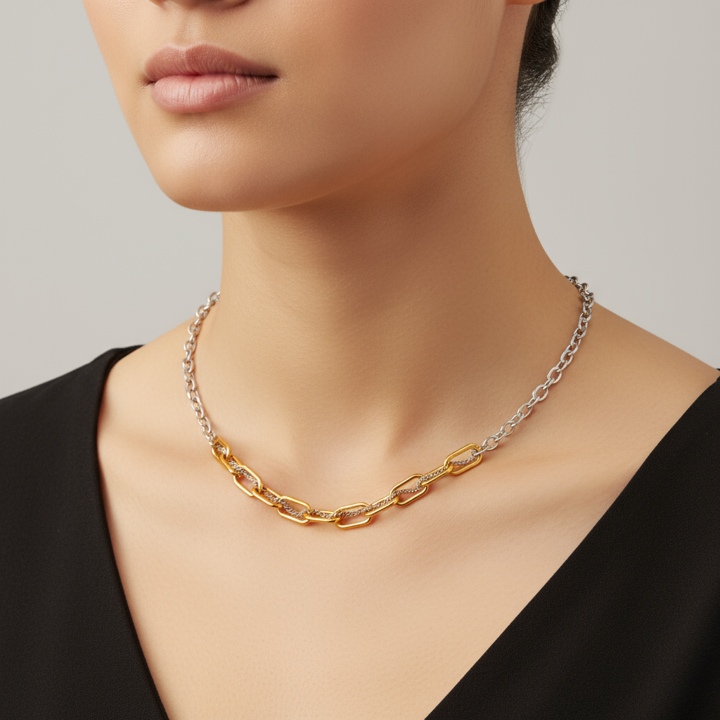 Necklace with gold and silver chain worn by a model against a neutral background