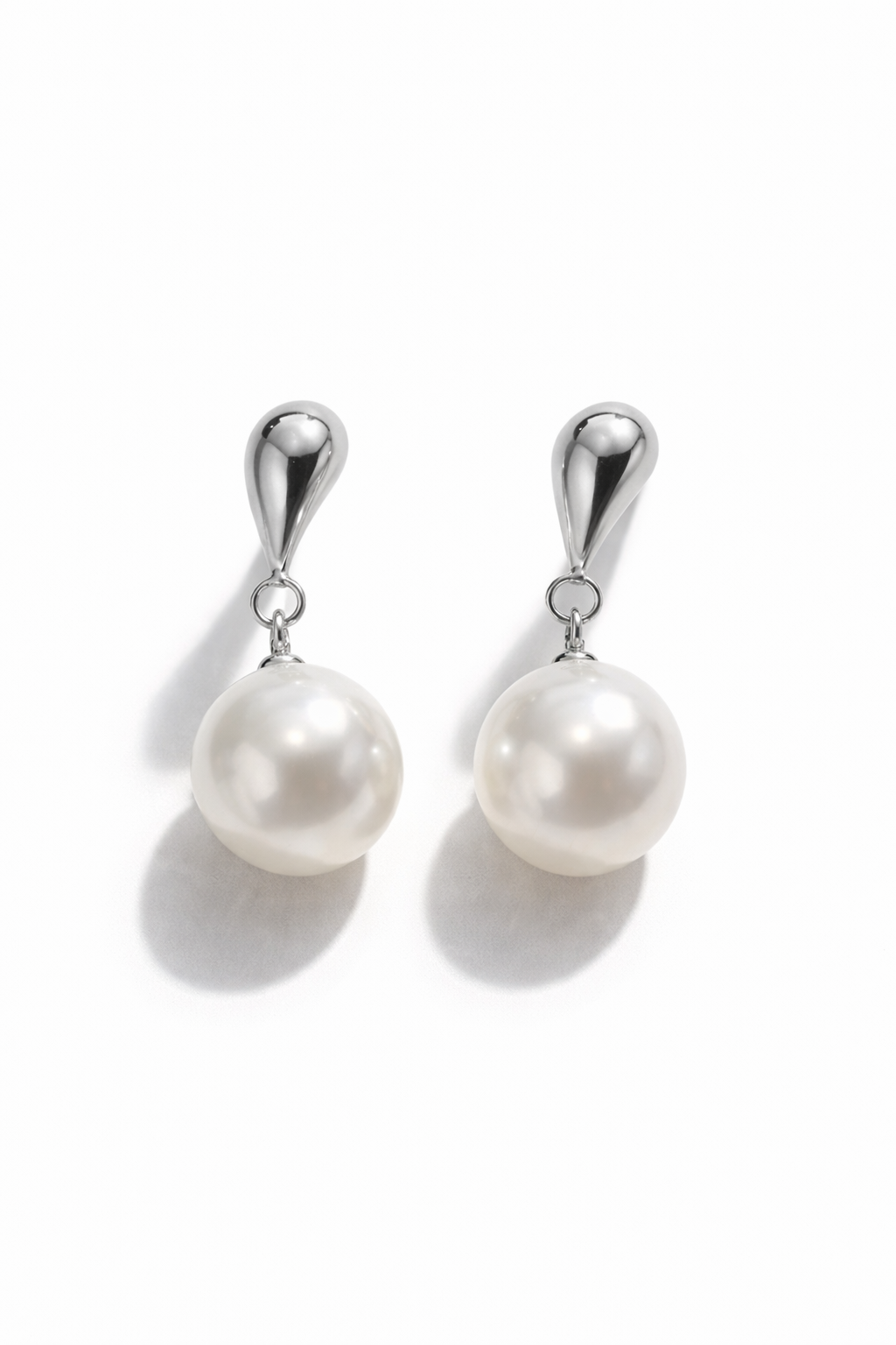 Pearl earrings with silver hooks on a white background