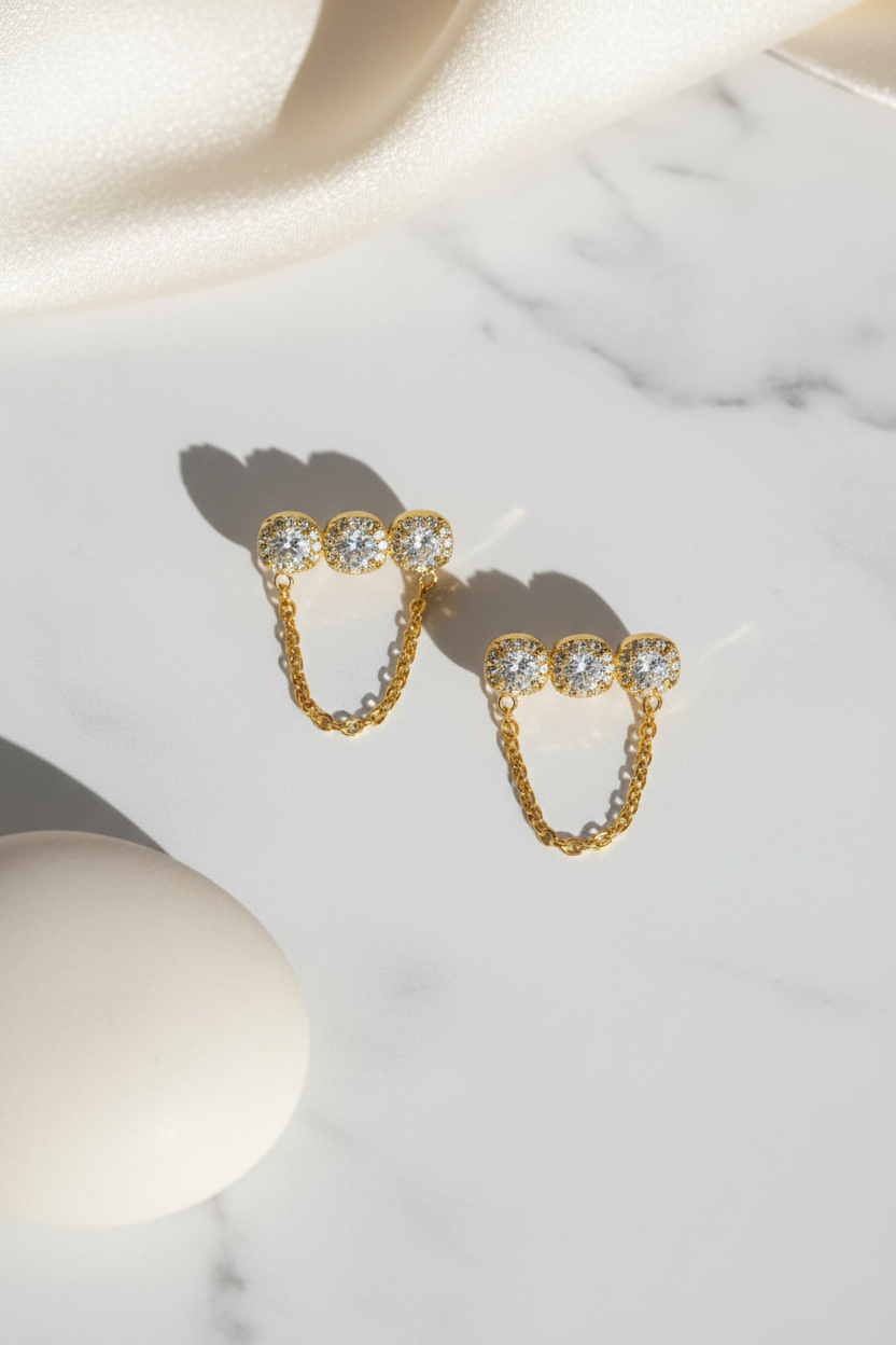 Trinity Chain Earrings ατσάλινα σκουλαρίκια με ζιργκόν και αλυσίδα σε χρυσό – So Cute by Dimi