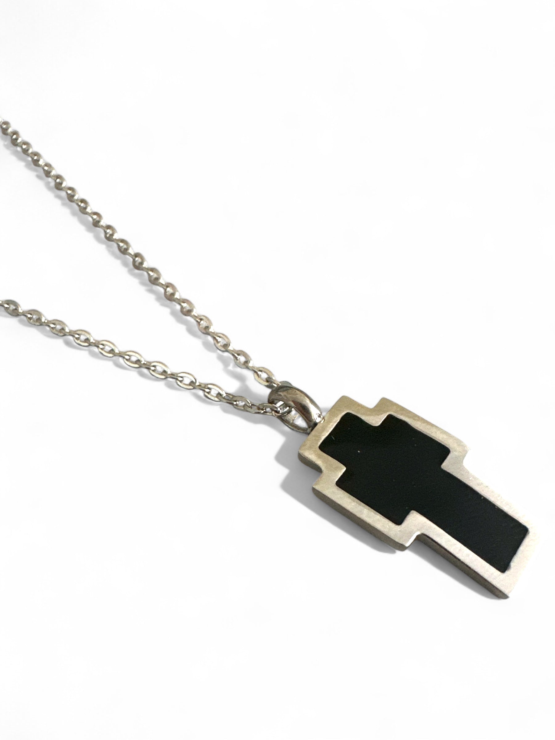 Necklace with a black and gold cross pendant on a white backgroundPixel Cross Necklace – Ατσάλινο Κολιέ  – Χονδρική So Cute by Dimi